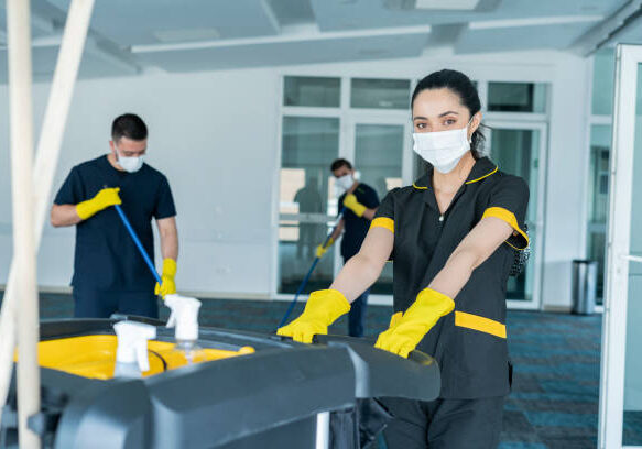 Cleaning staff composed of men and women of Latino ethnicity between the ages of 20-30 are cleaning the building to avoid the risk of contagion by COVID-19
